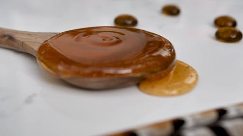 Close Up View of Honey on a Wooden Spoon