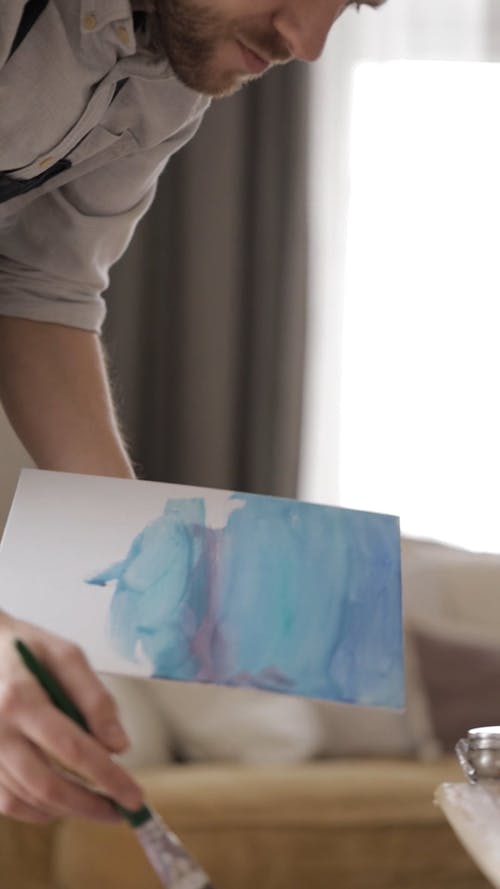 Man Painting In A White Board