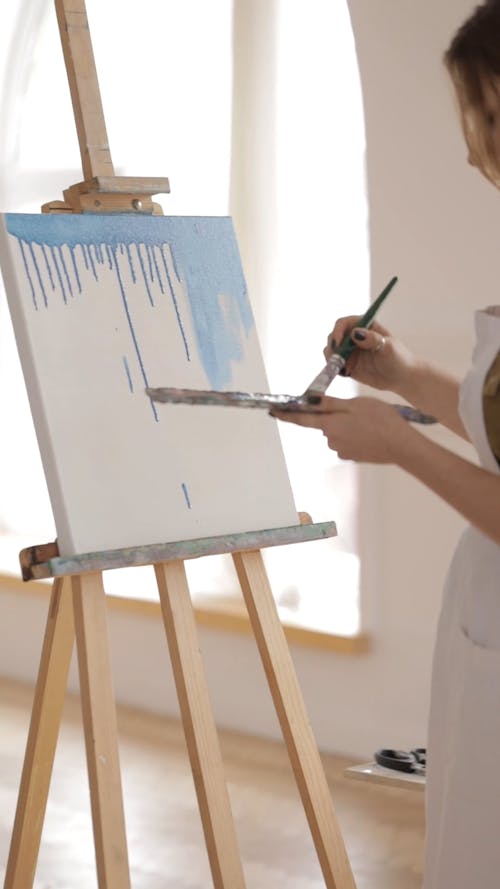 Woman Painting In A White Board