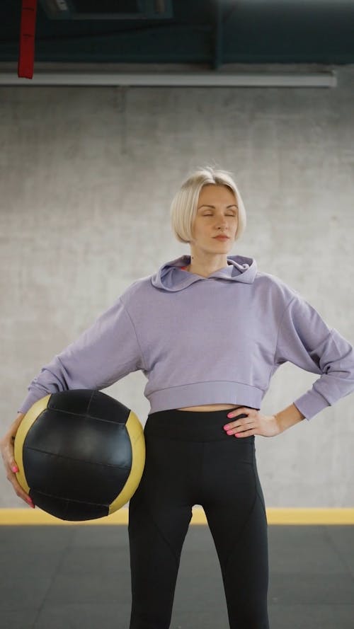 A Woman Posing With An Exercise Ball