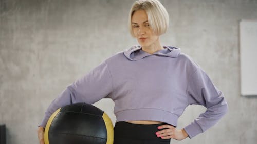 A Woman Holding An Exercise Ball