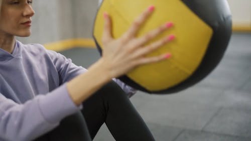 A Woman Exercising Using An Exercise Ball