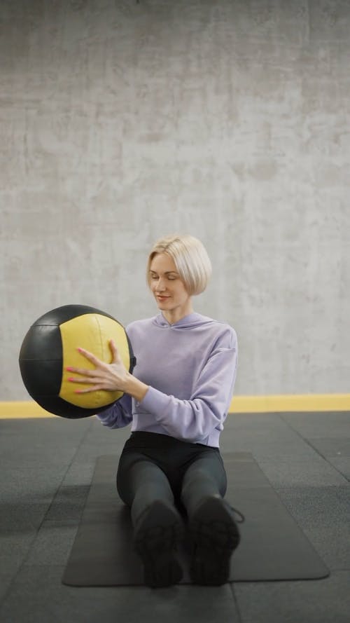 A Woman Exercising With An Exercise Ball