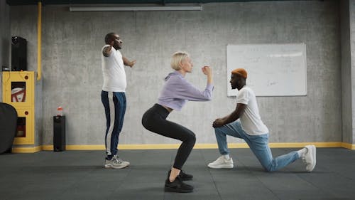 A Group Of People Exercising In The Gym