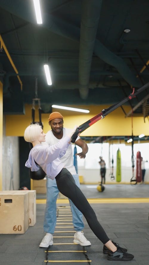 A Trainer Training A Woman In The Gym