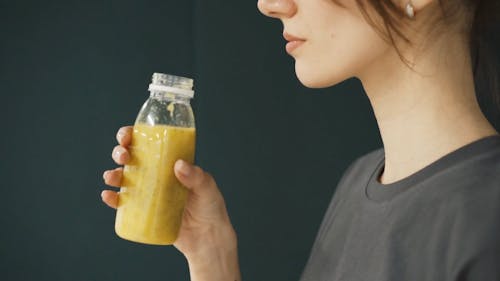 A Woman Drinking A Healthy Drink