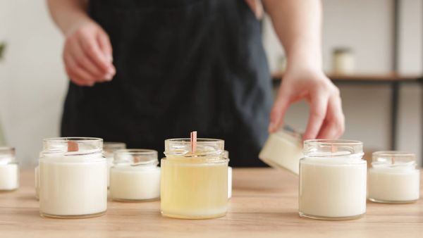 Scented candle burning with visible fragrance