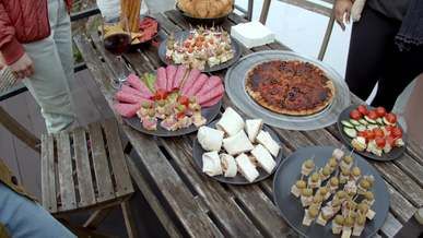 people picking foods from the table