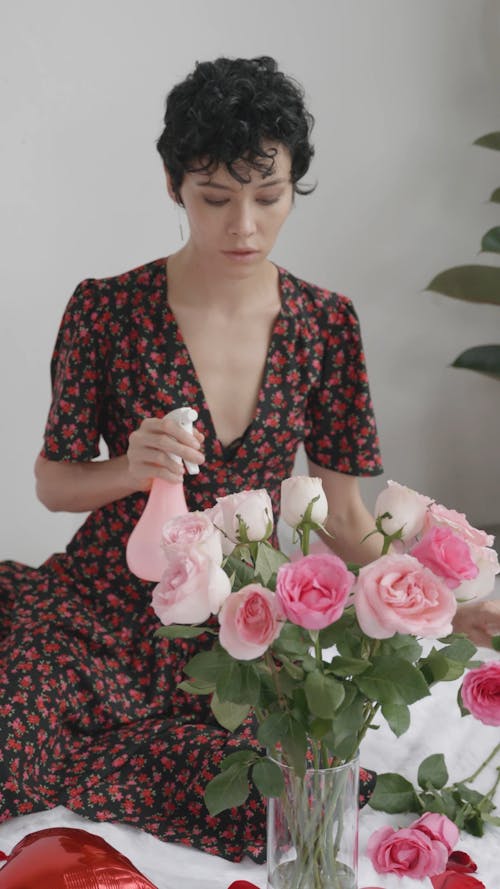 Woman Arranging the Flowers in a Vase