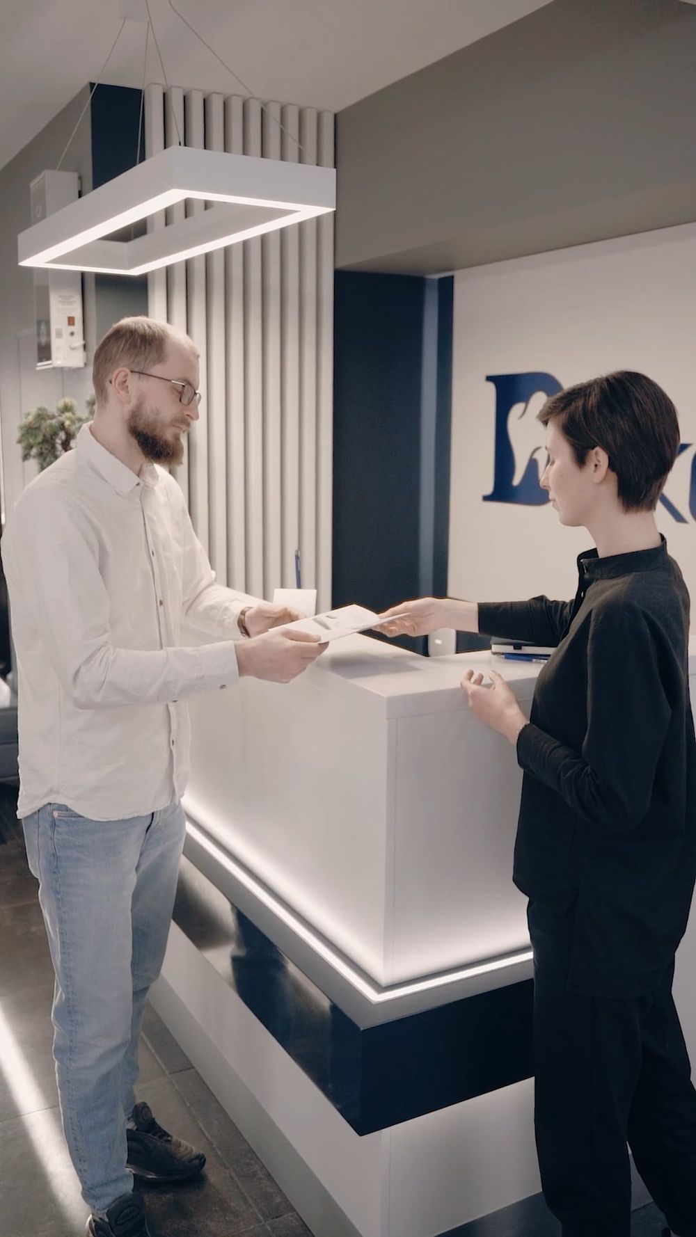 A Woman Standing In Front Of A Dental Clinic Free Stock Video a-woman-standing-in-front-of-a-dental-clinic-free-stock-video