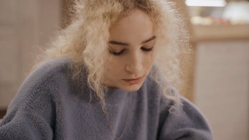 A Woman Writing Down Her Idea on the Paper