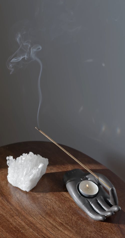 Burning Candle and Incense Stick on Hand Shaped Holder