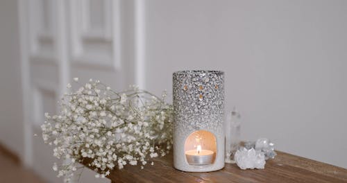 Close-Up View of a Person Putting Essential Oil on a Diffuser