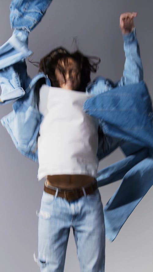 Man Wearing Denim Jacket Jumping