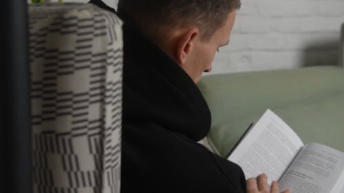 Close-up Footage of a Man Reading a Book
