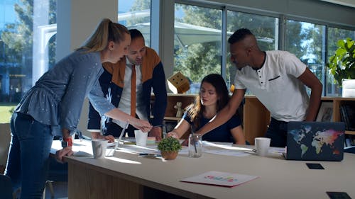 A Group Of People Discussing In A Business Meeting