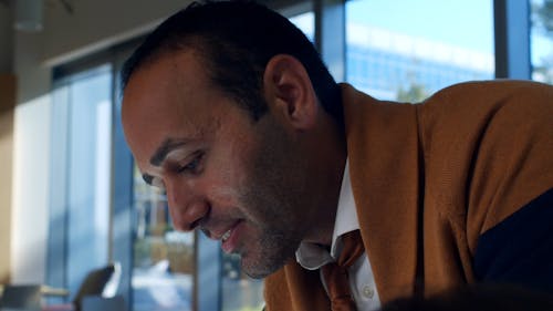 A Man Smiling While Talking In A Business Meeting