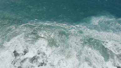 drone footage of sea waves crashing on seashore