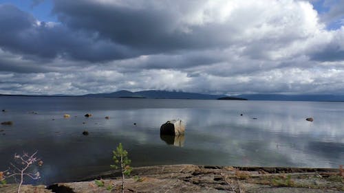 A Calm Water Over a Cloudy Sky