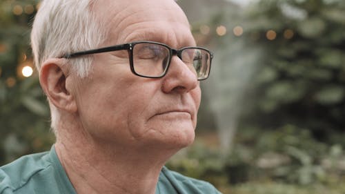 Close-Up View of Man Wearing Eyeglasses Smiling