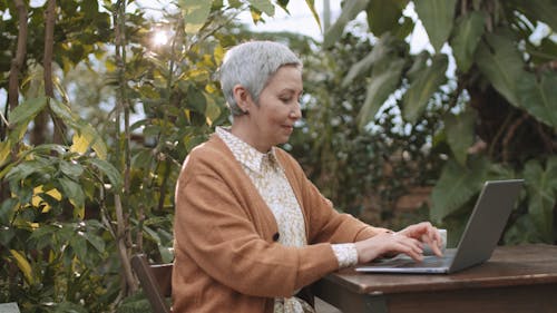 Woman Busy Using Her Laptop While Drinking Coffee