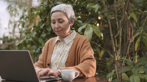 Woman Busy Using Her Laptop While Drinking Coffee