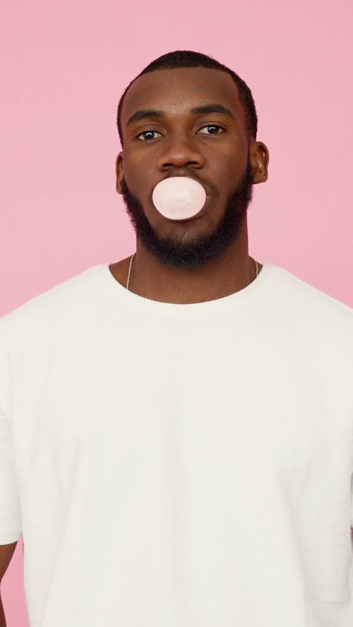 A Man Blowing a Bubble Gum