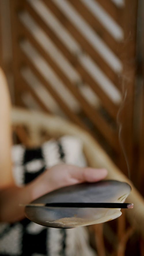 A Woman Holding Lighted Incense 