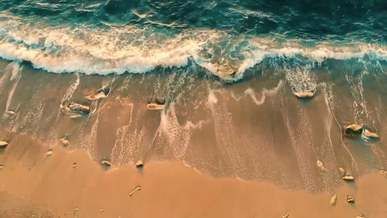 drone footage of crashing waves on seashore