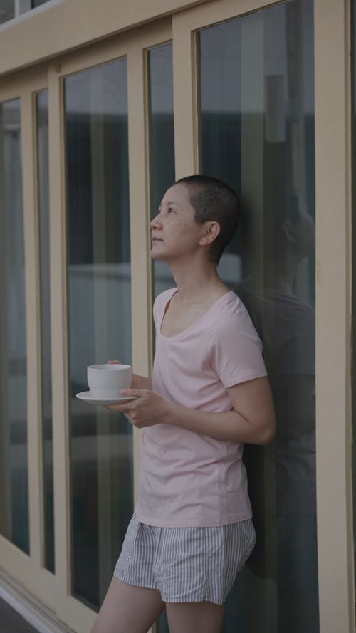 A Woman in Deep Thought while Drinking a Coffee