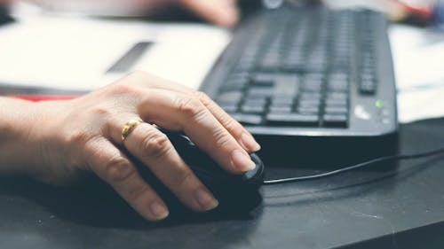 Close-Up View of a Person Using a Computer Mouse