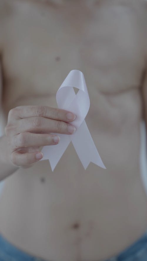 A Person Holding a Pink Ribbon