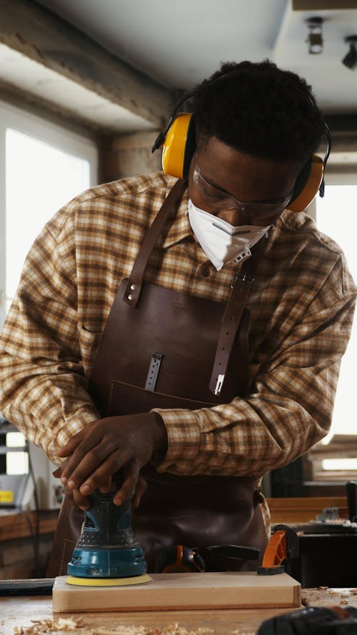 Man Polishing Piece of Wood