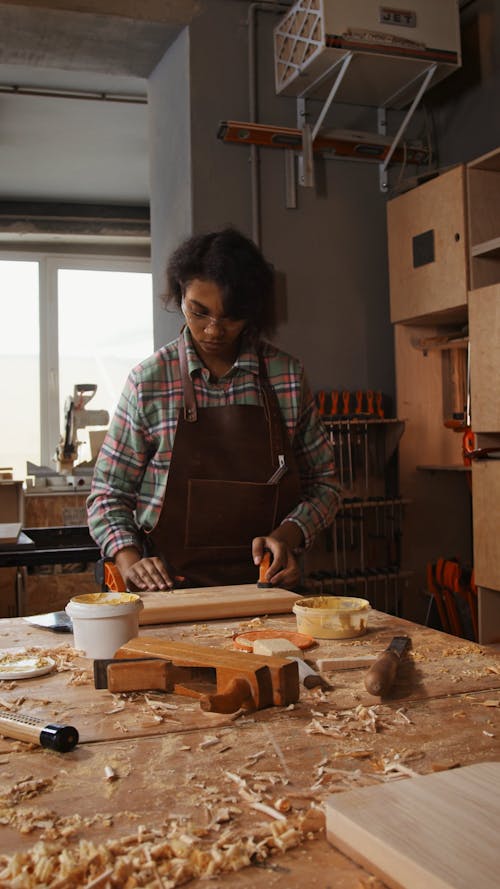 Woman Putting Wood Putty on Block of Wood