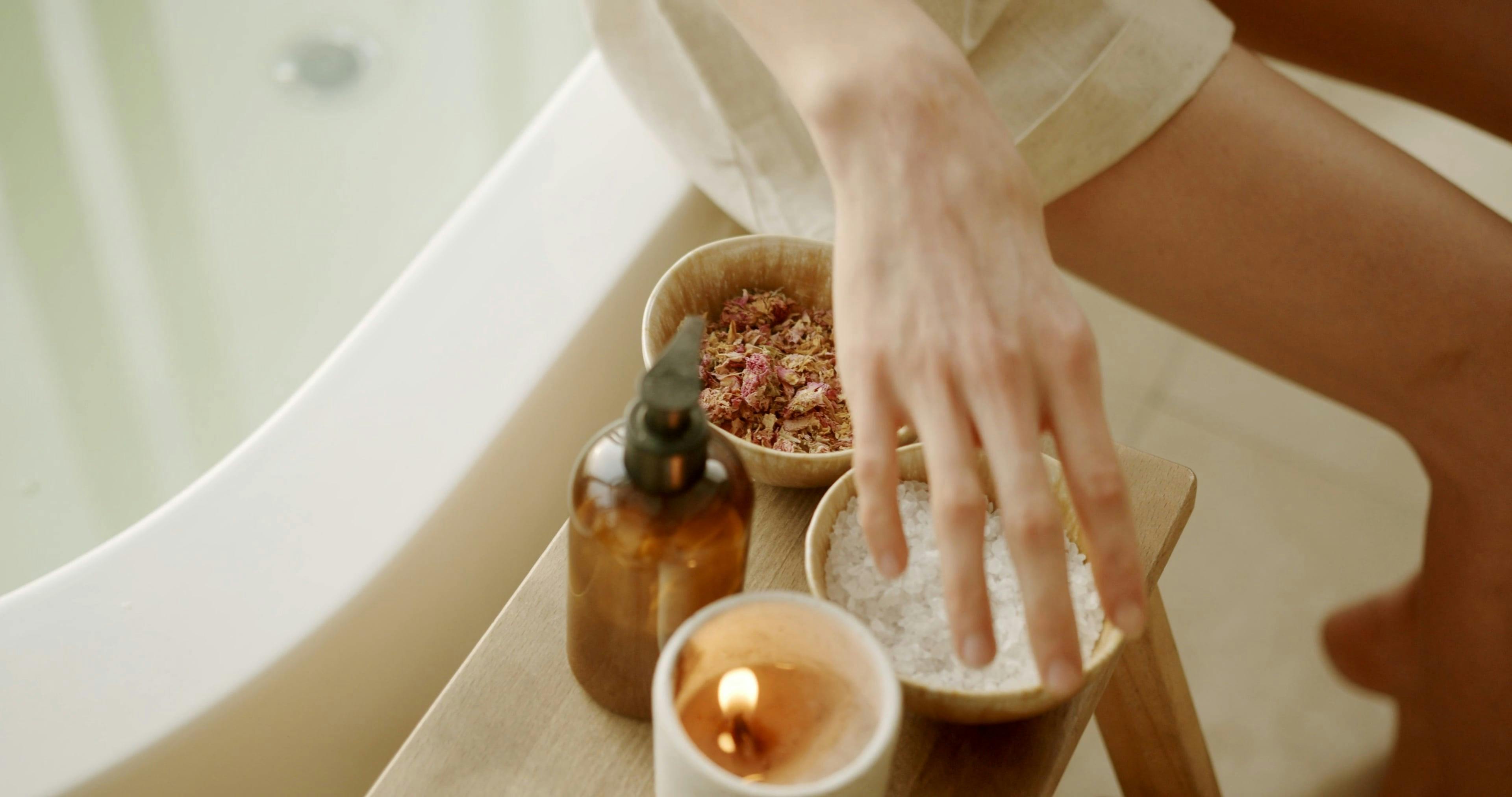 CloseUp View of a Person Putting Bath Salt in a Bathtub · Free Stock Video