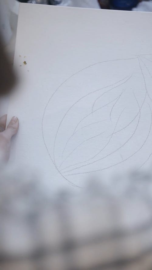 A Person Drawing on White Paper