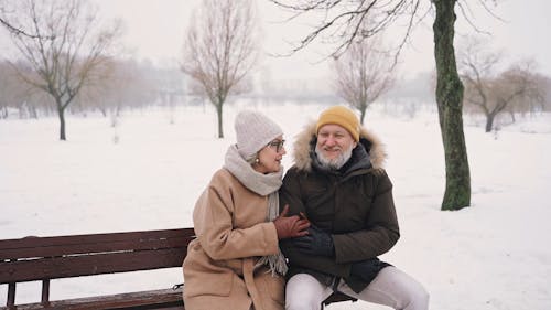 A Couple Talking While Sitting on the Bench