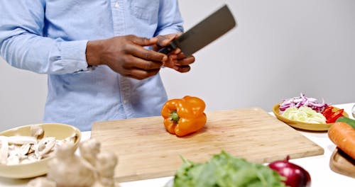 A Person Cutting a Bell Pepper 