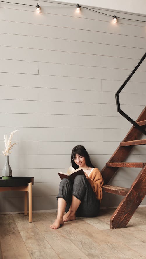 Woman Caressing Dog While Holds A Book