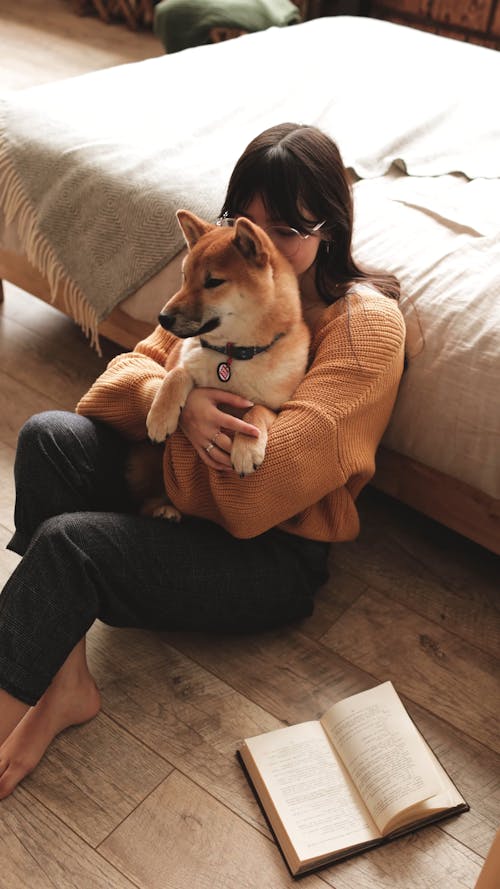 Woman Holding Dog On Arms