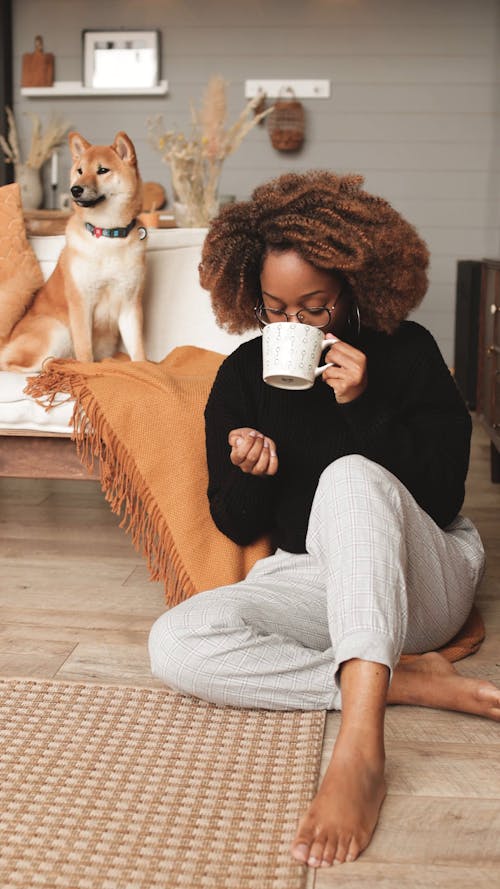 Woman Caressing Dog While Sit On Floor