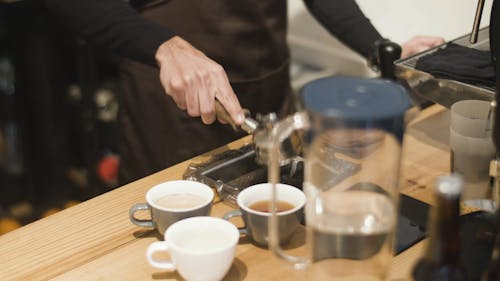 A Faceless Barista Preparing Coffee