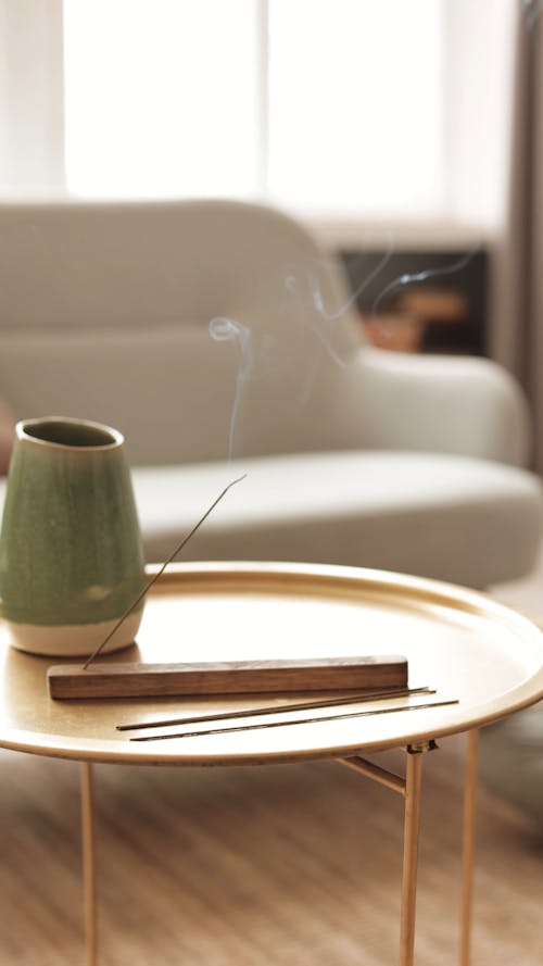A Burning Incense Stick on a Table