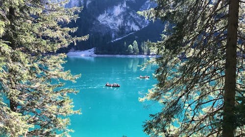 People Rowing a Boat in a Blue Lagoon