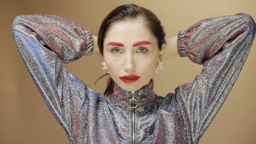 A Woman Posing while Wearing a Shiny Glitter Jacket