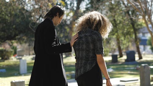 Man Comforting a Woman at the Cemetery