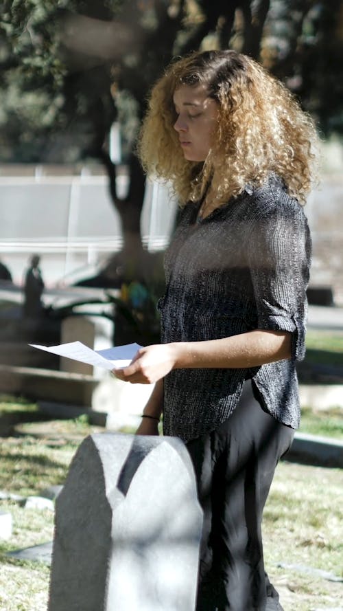 A Woman Reading a Letter for the Dead