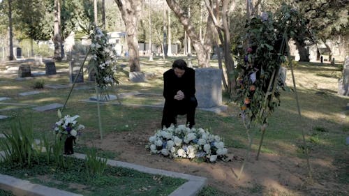 Man Kneeling at the Cemetery