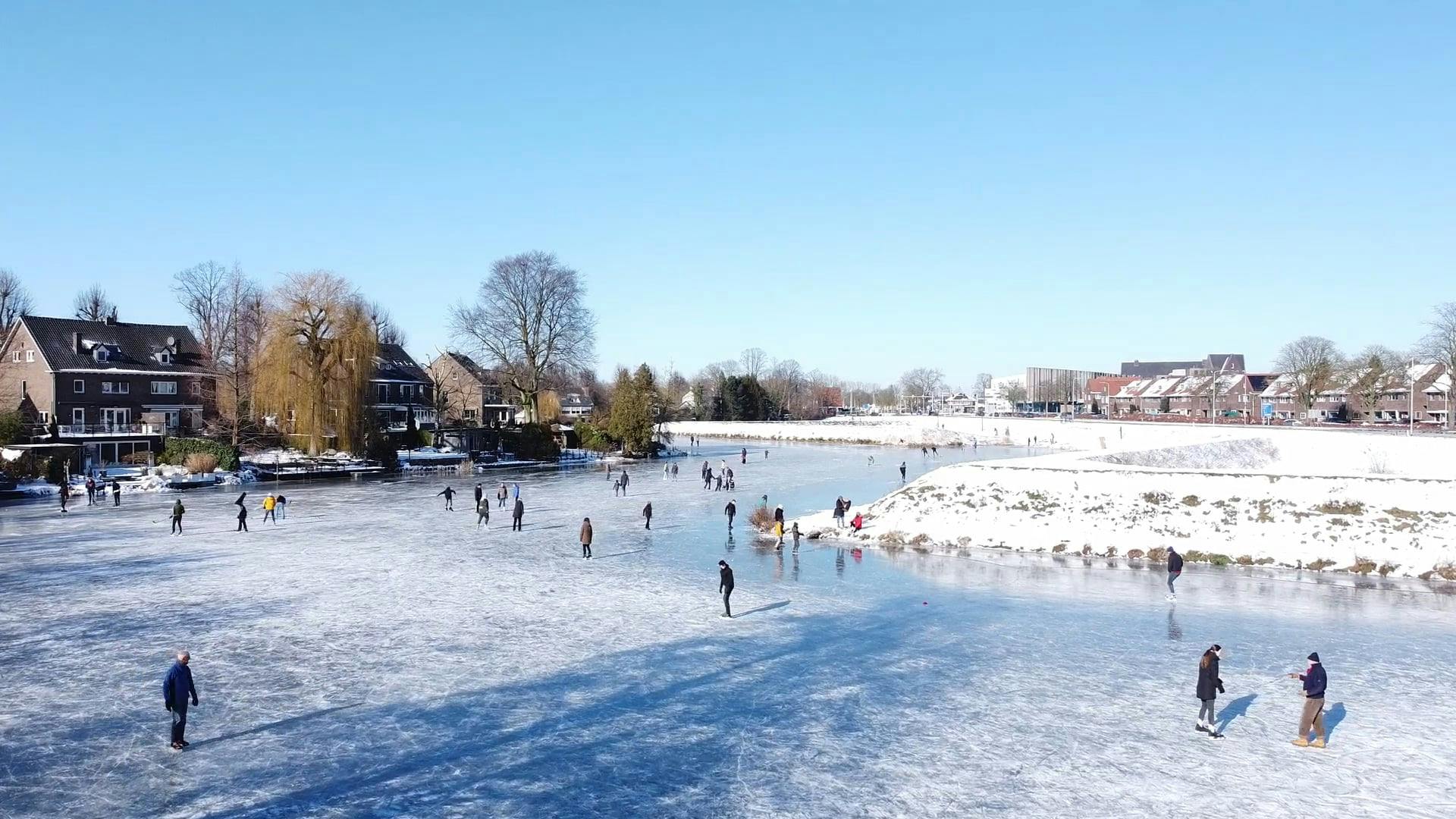Drone Footage of People Ice Skating on a Frozen Lake · Free Stock Video