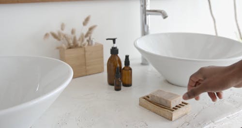 A Man Getting a Soap from the Soap Dish